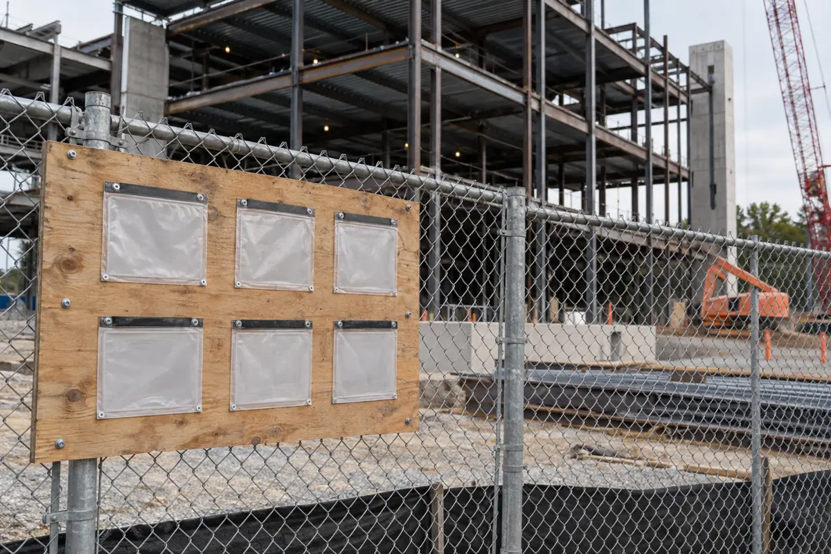 Permit board on the fence of a commercial construction site