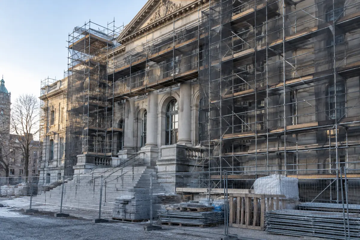 Municipal building facade covered in scaffolding during renovation work
